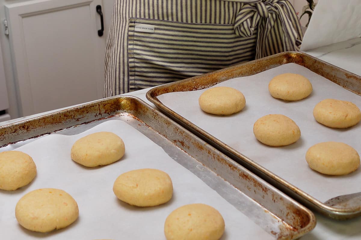 Sourdough sweet potato dough rolls on baking sheet after shaping the rolls.