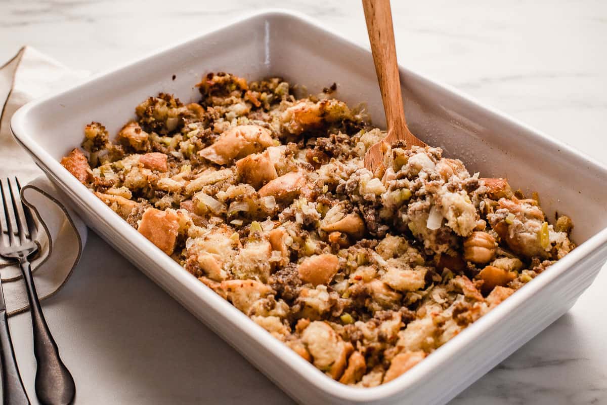 Sausage bread dressing in a serving dish on a counter.