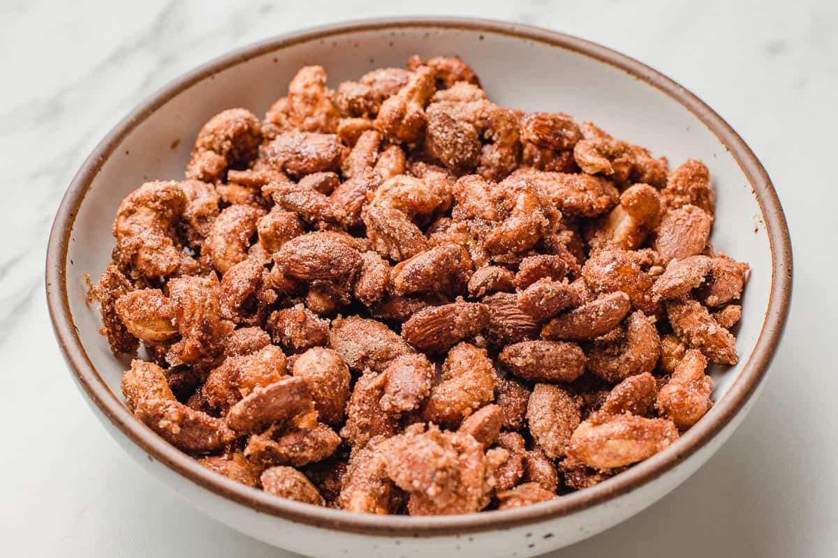 Almonds and cashews that have been candied, in a bowl.