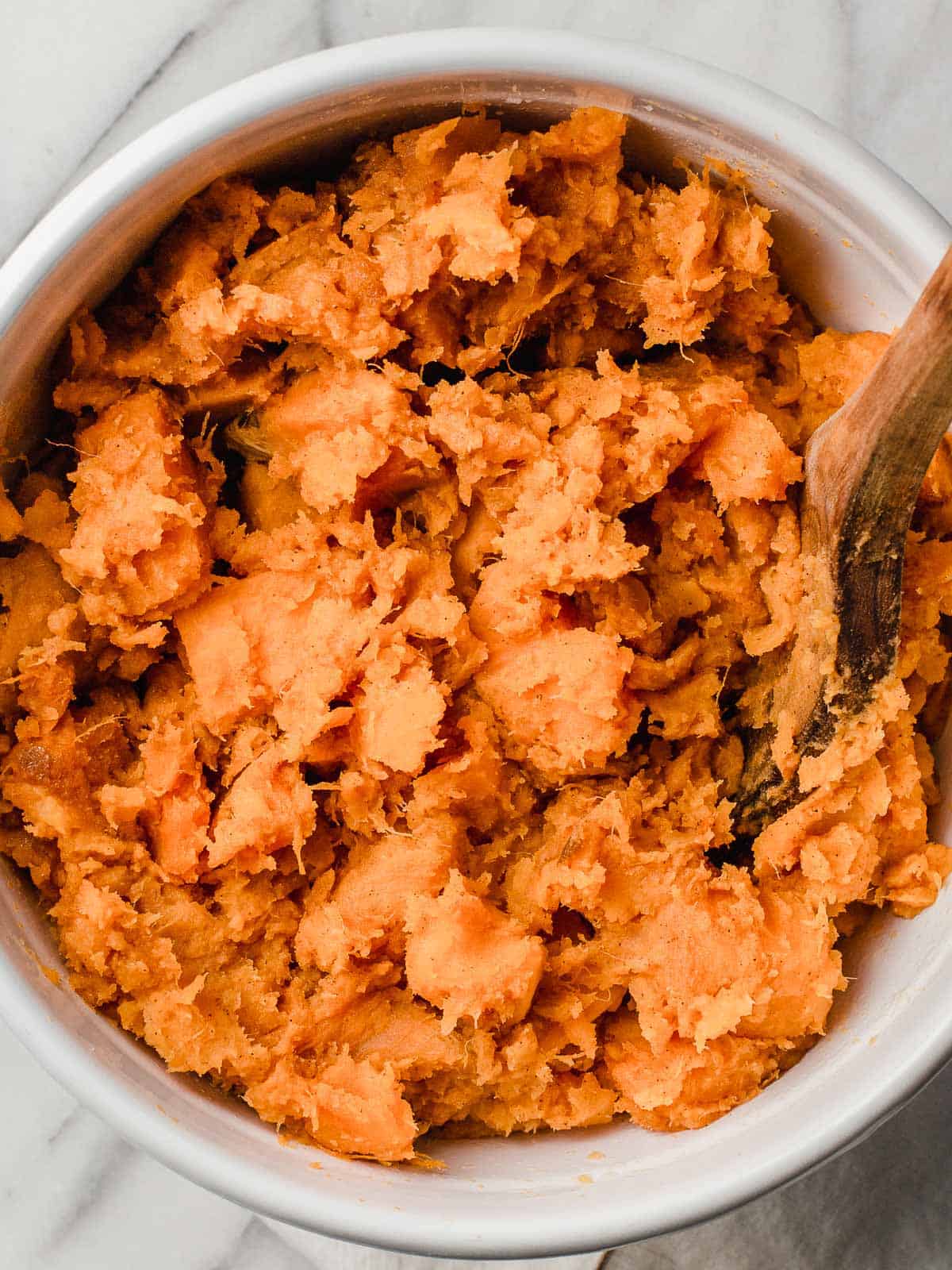 Sweet potatoes mashed in a bowl.