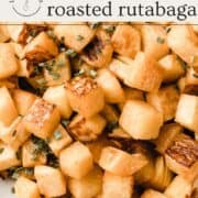 Roasted rutabaga in a bowl topped with chives.