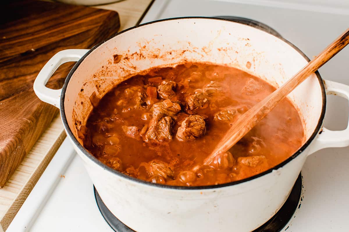 Hungarian beef goulash in a dutch oven on the stove.