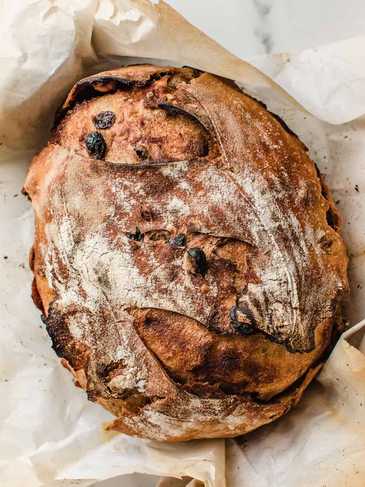 A loaf of cinnamon raisin swirl sourdough bread on the table.