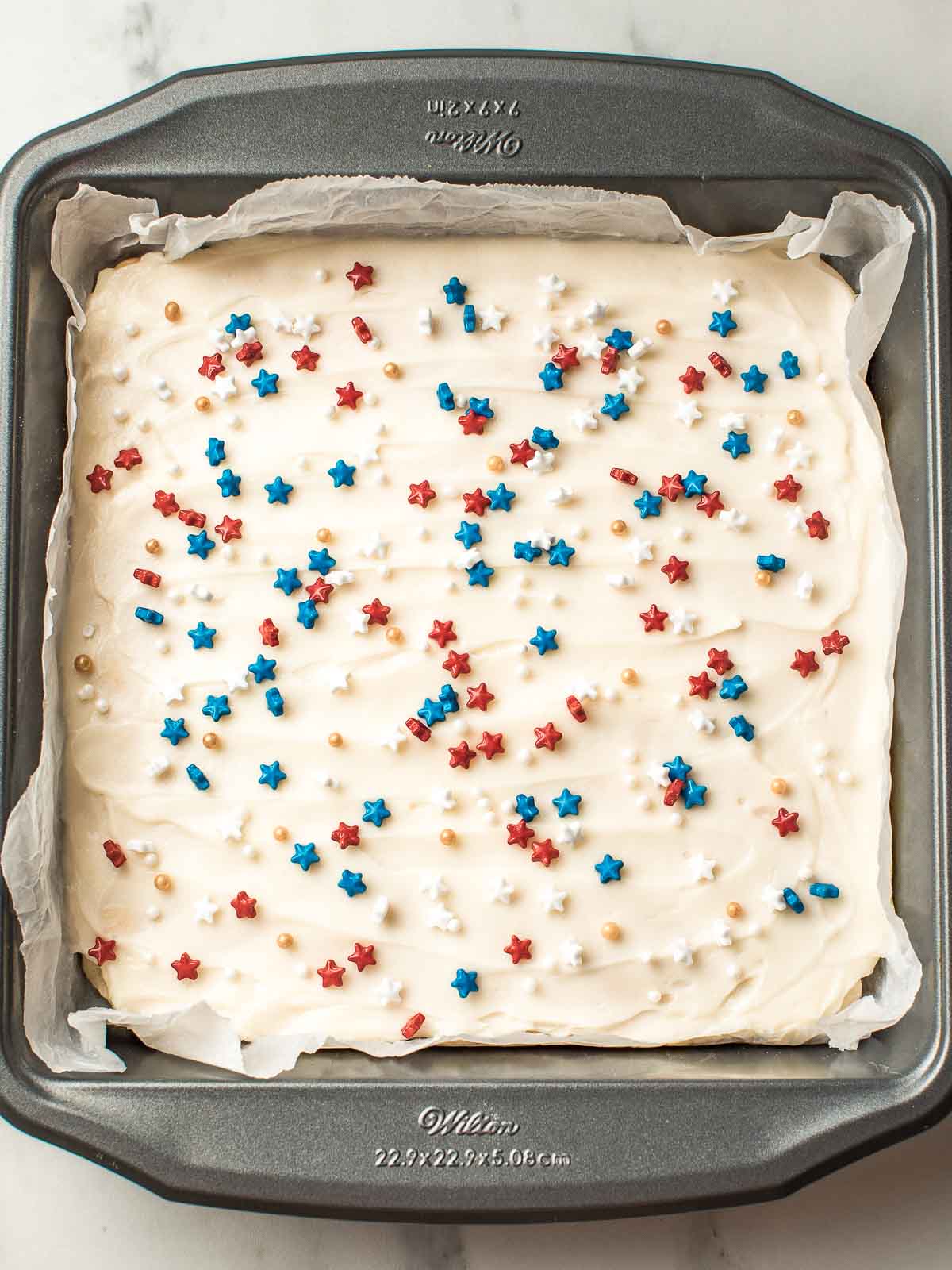 A baking tin with decorated sourdough cookie bars.