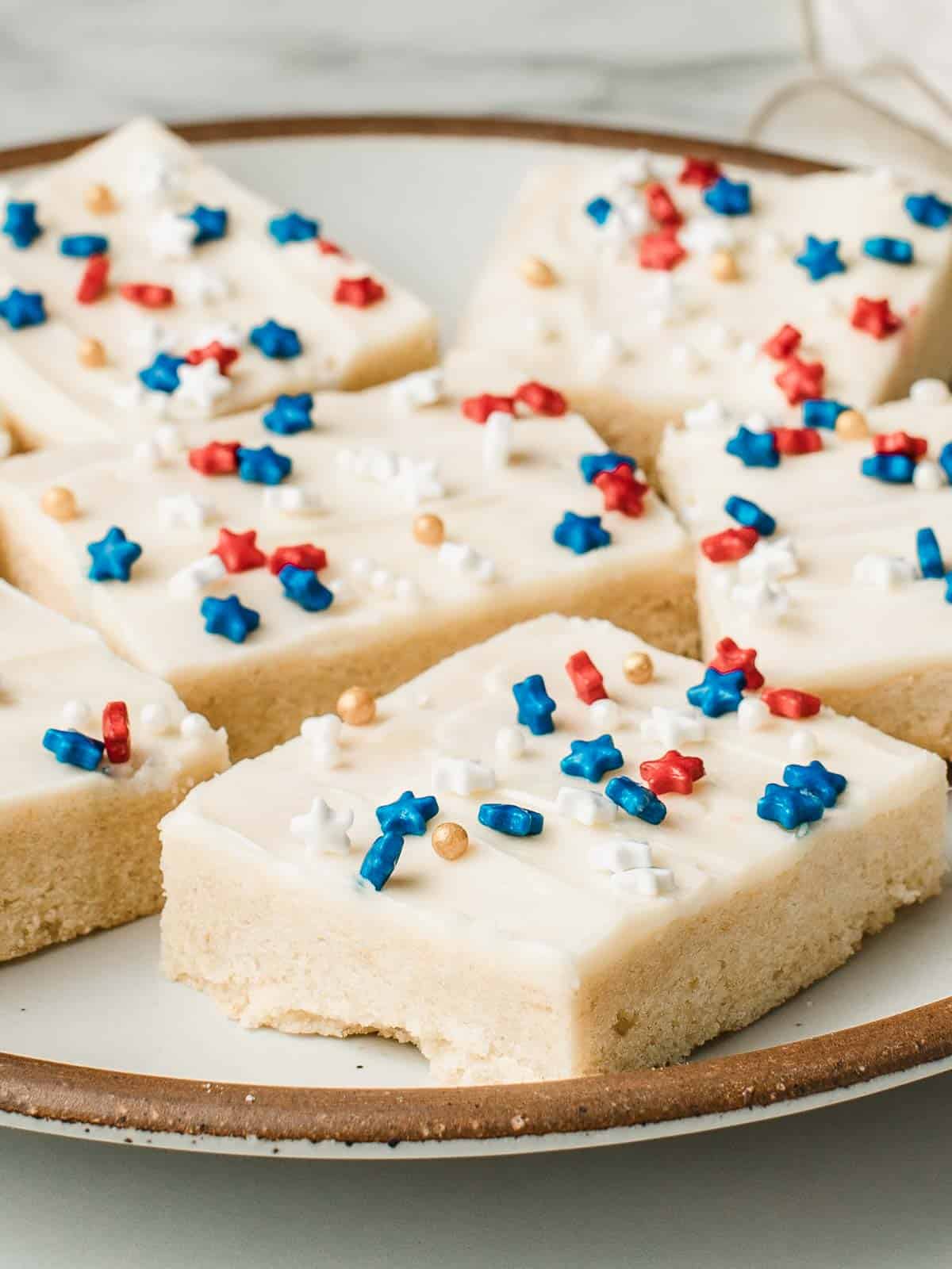 A plate of sourdough sugar cookie bars with sprinkles.