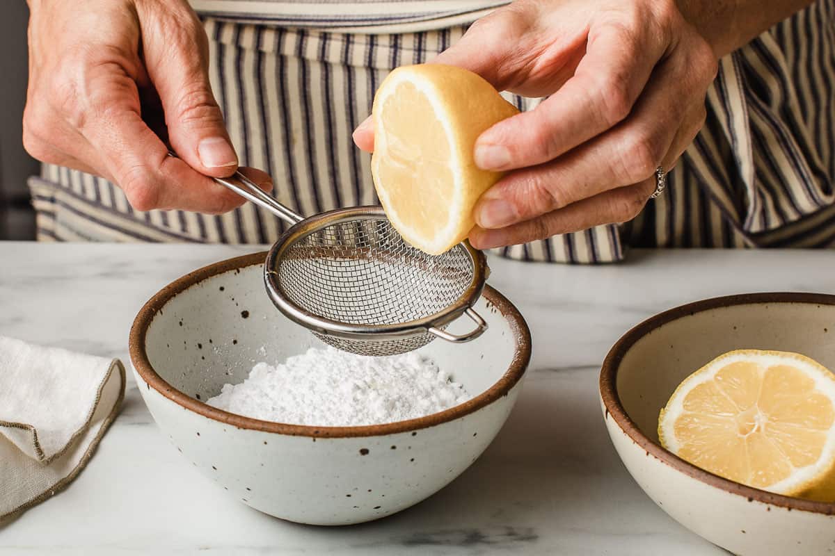 A woman making a lemon sugar glaze.