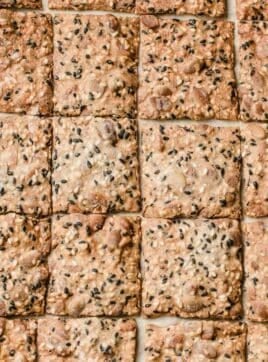 A closeup photo of a tray of sourdough seed crackers.