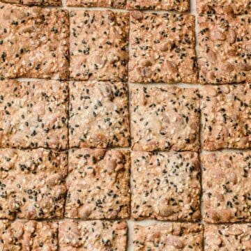 A closeup photo of a tray of sourdough seed crackers.
