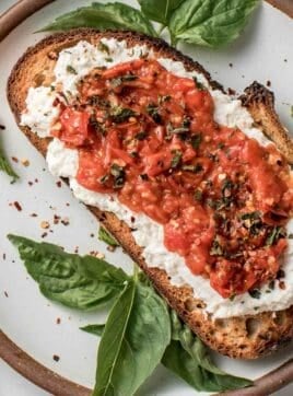 Cherry tomato toast on a plate.