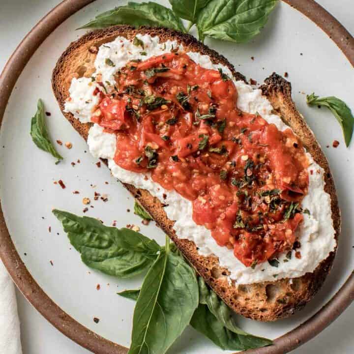Cherry tomato toast on a plate.