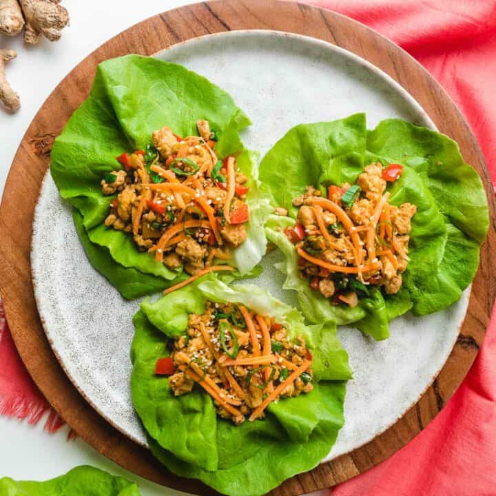 Asian chicken lettuce wraps on a white plate.