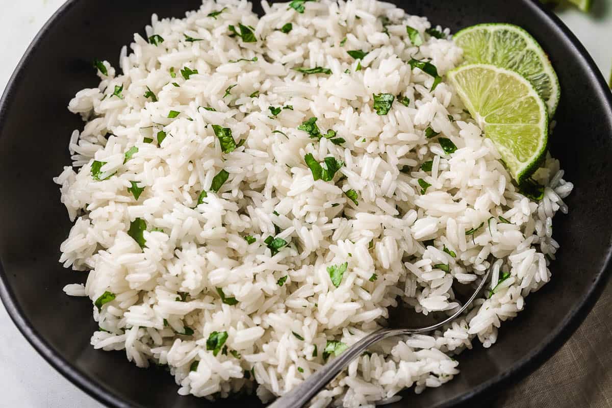 Closeup photo of cilantro lime rice in a black bowl.