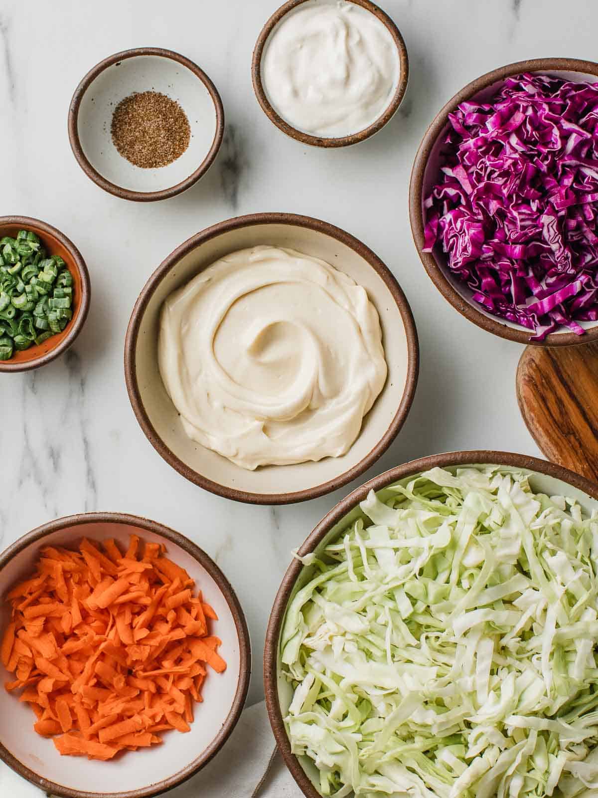 Creamy coleslaw ingredients on a table.
