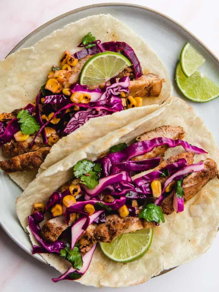 Two chicken tacos on a plate.