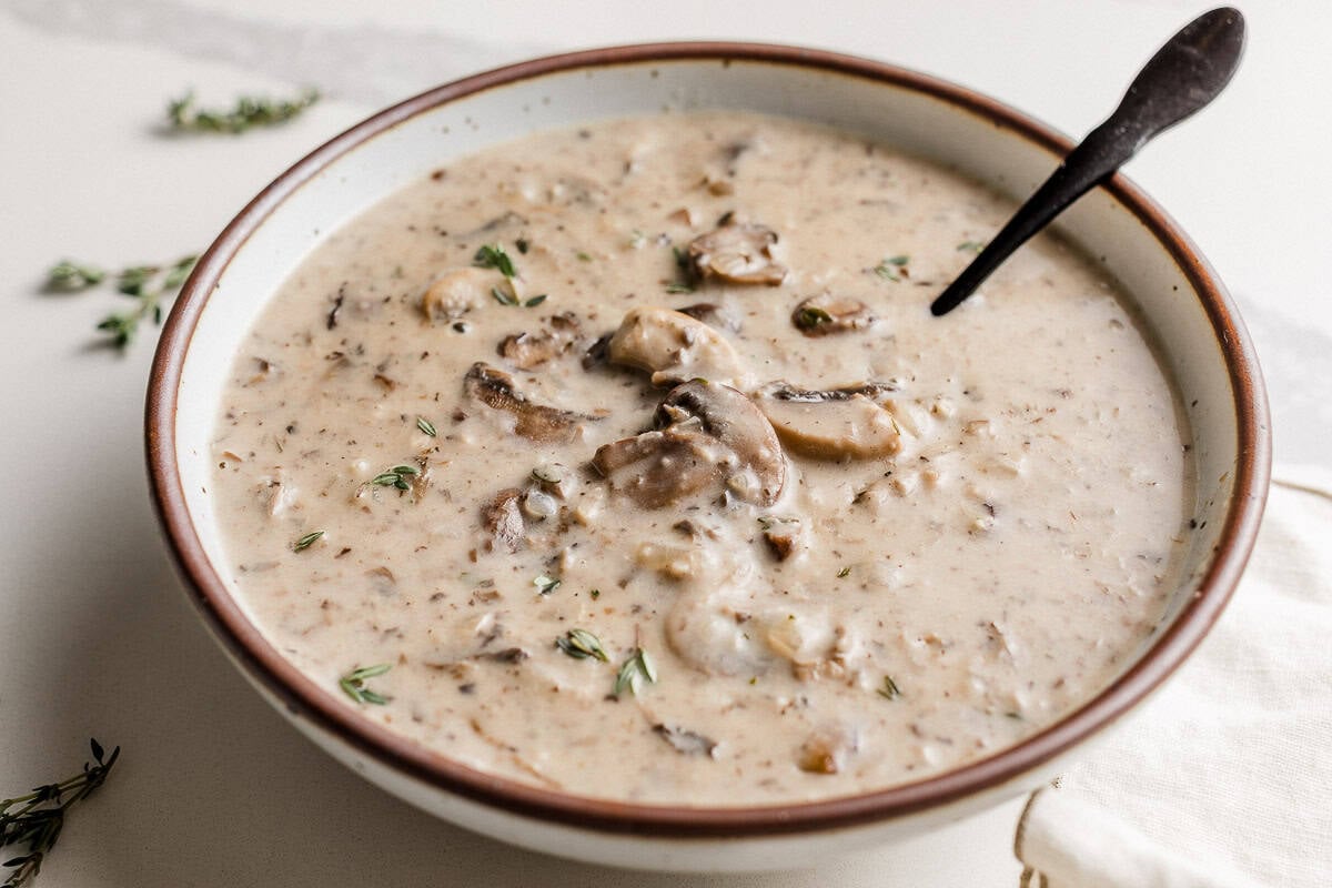 Creamy mushroom soup in a bowl on the table.