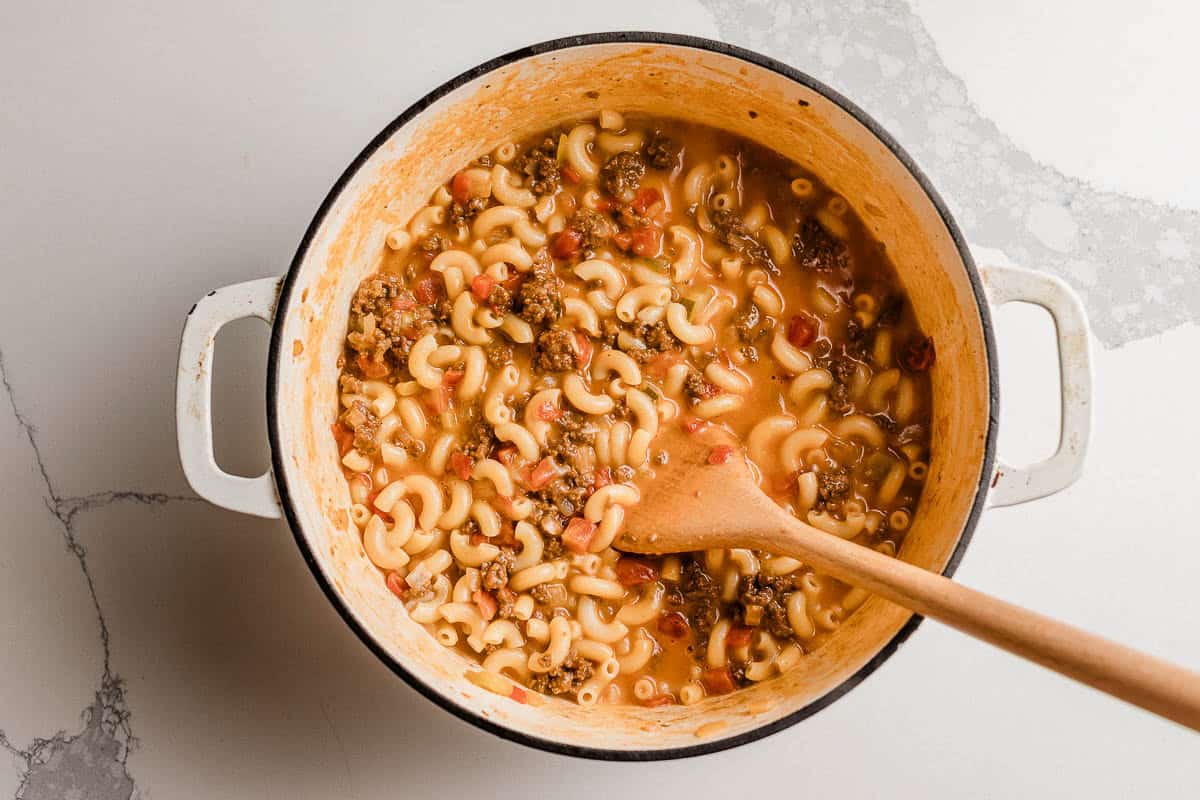 Cheeseburger  casserole ingredients cooking in a pot.