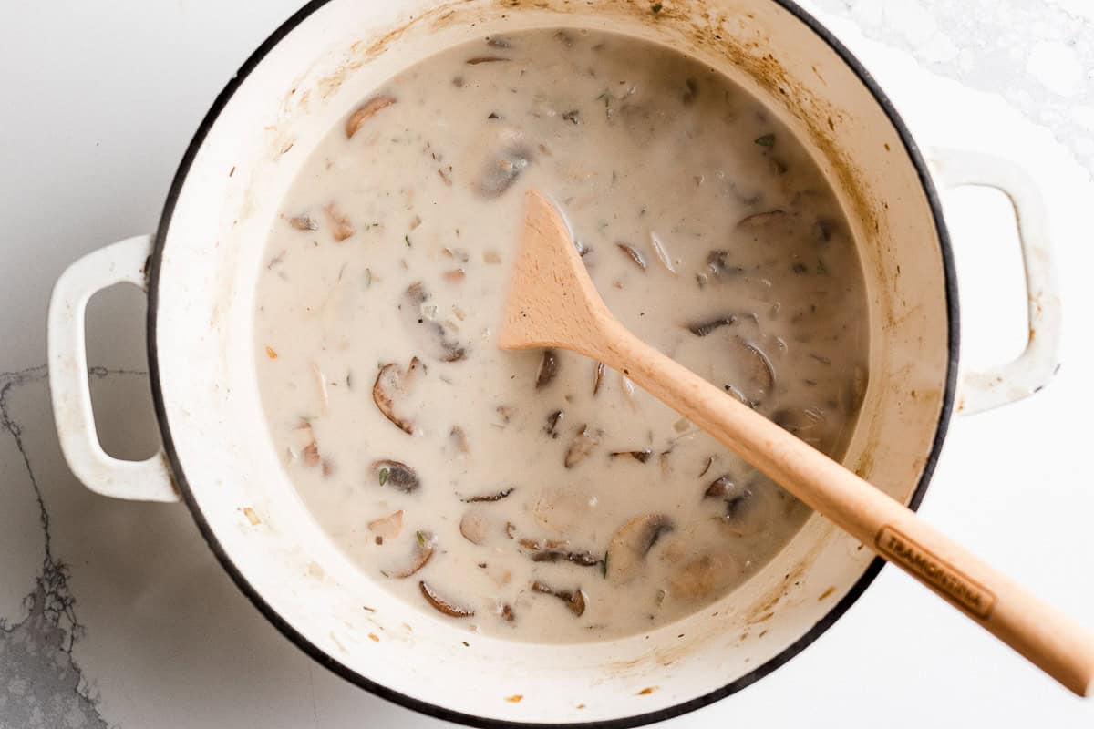 Mushroom soup cooking in a dutch oven pot.