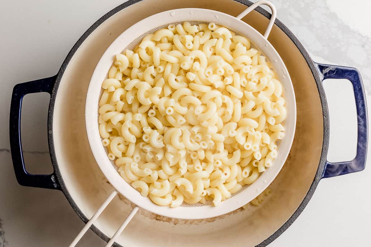 Noodles draining over a pot.