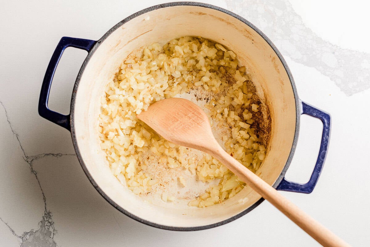 Garlic and onions cooking in a soup pot.