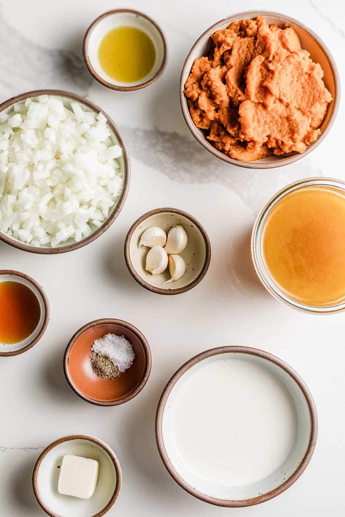 Ingredients for pumpkin soup on a table.