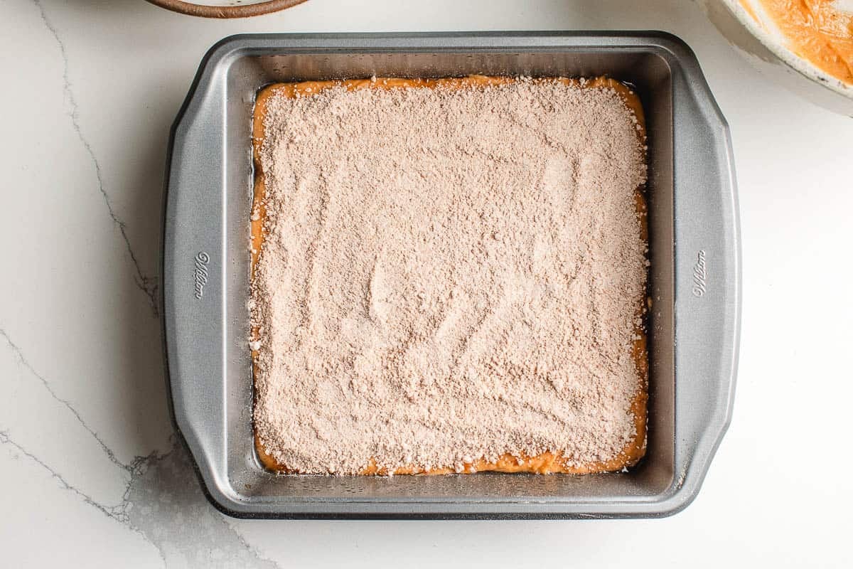 Second layer sourdough pumpkin coffee cake batter in a dish.