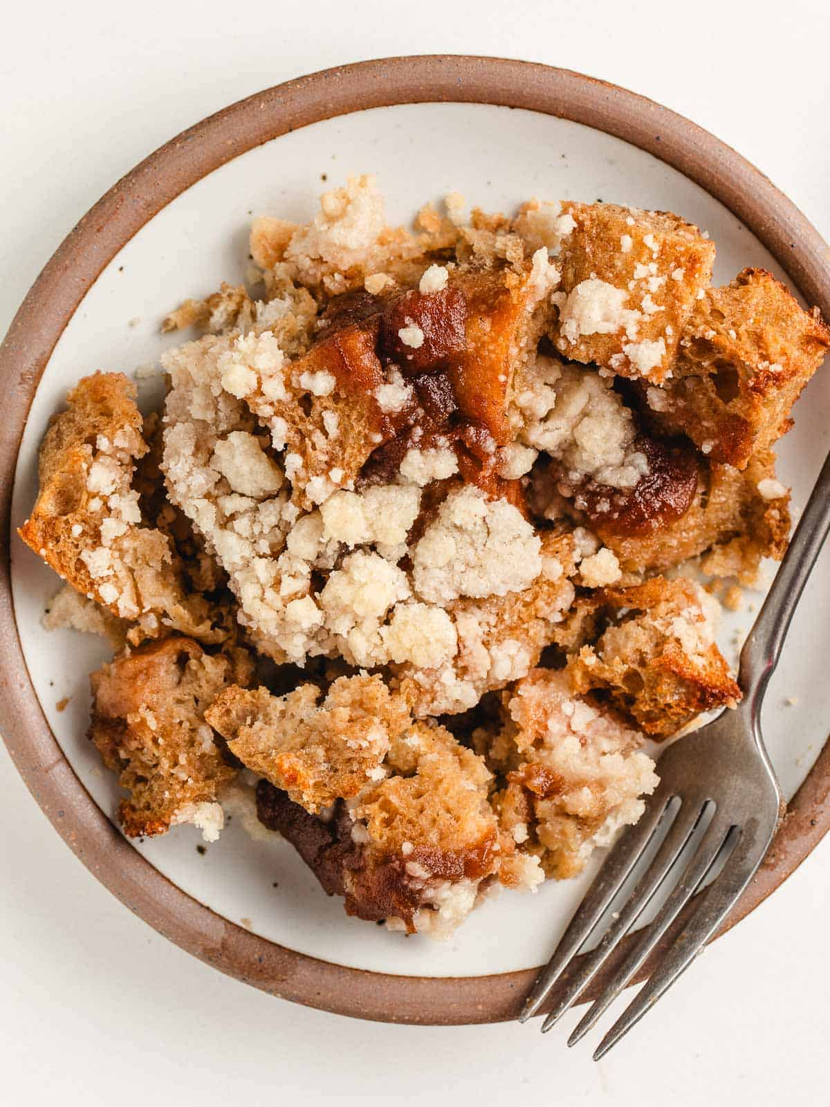 A plate of sourdough french toast casserole with a fork.