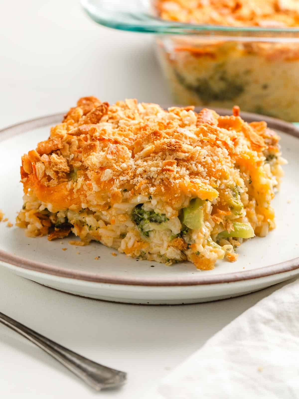 A serving of broccoli rice casserole on a plate.