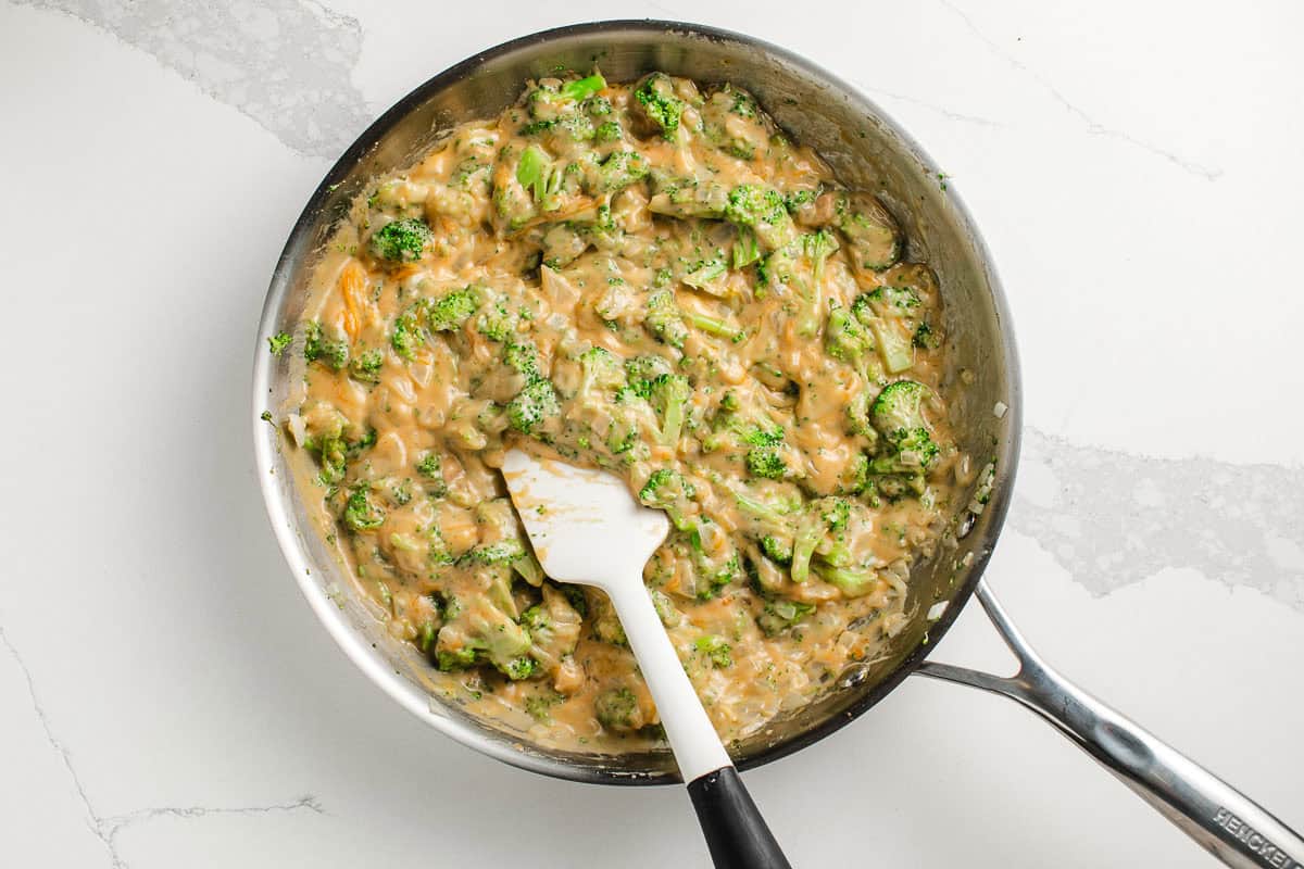 Broccoli rice casserole sauce ingredients in a pan.