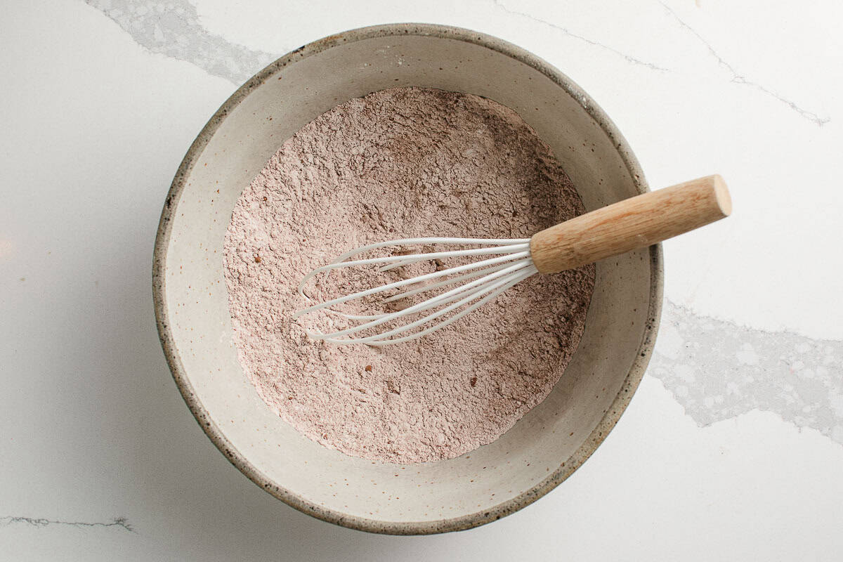 Dry ingredients for sourdough red velvet waffles in a bowl.