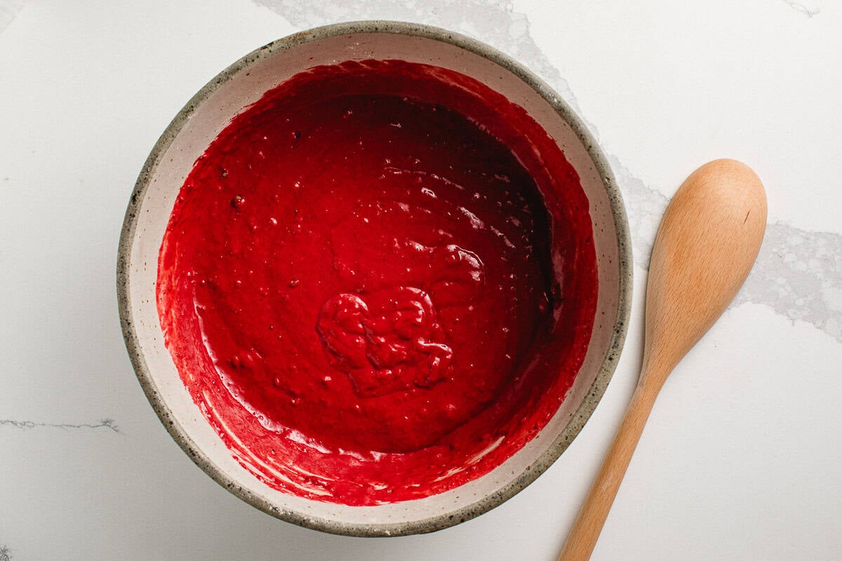 sourdough red velvet waffle batter in a bowl on a table.