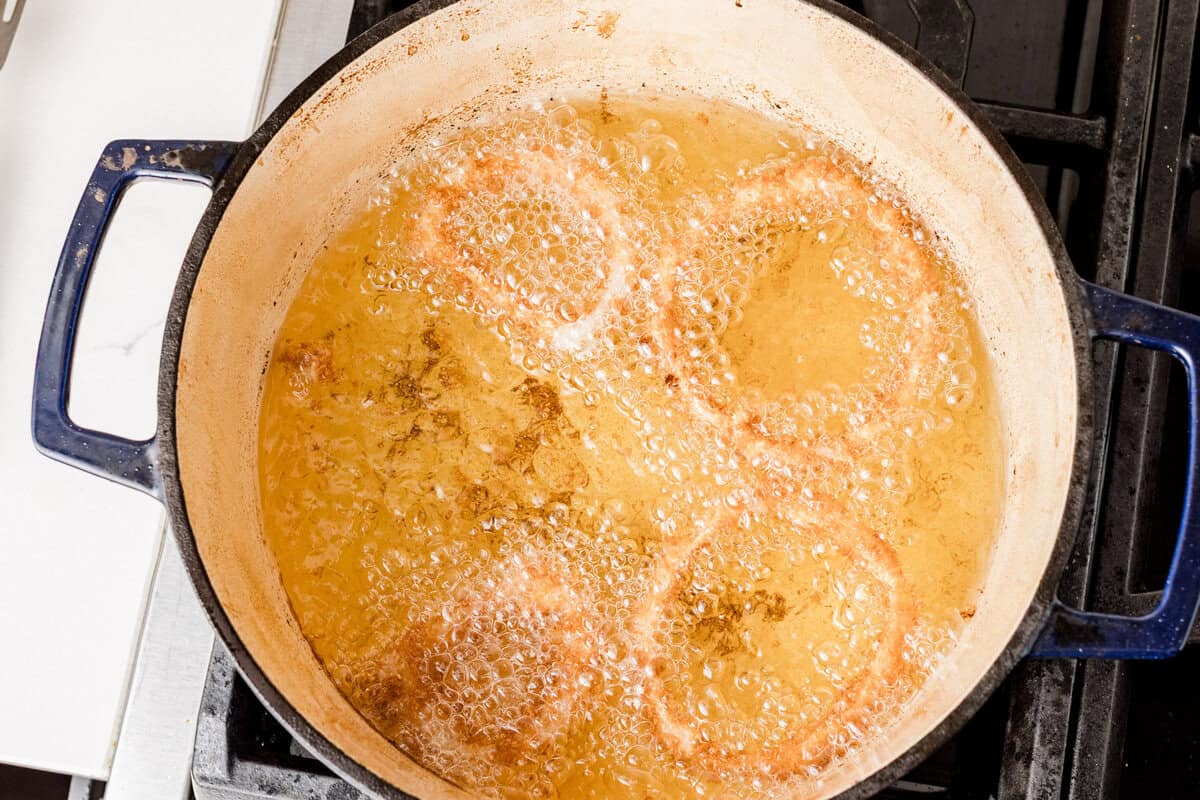 Frying onion rings in a dutch oven.