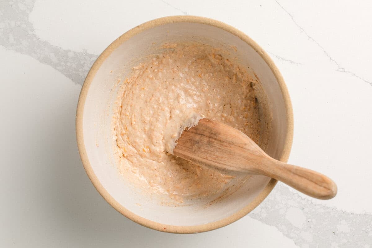 Ingredients for sourdough cheeze-its mixed together in a bowl.