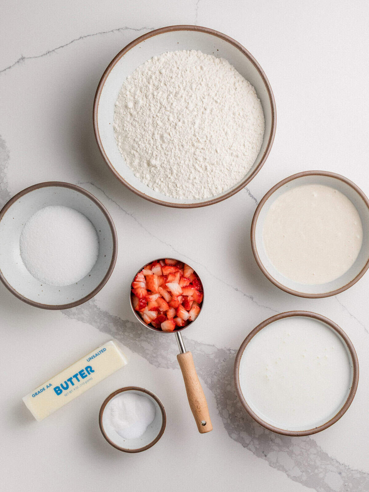 Ingredients for sourdough strawberry biscuits on a table.