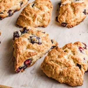 Sourdough lemon blueberry scones baked on a baking sheet.