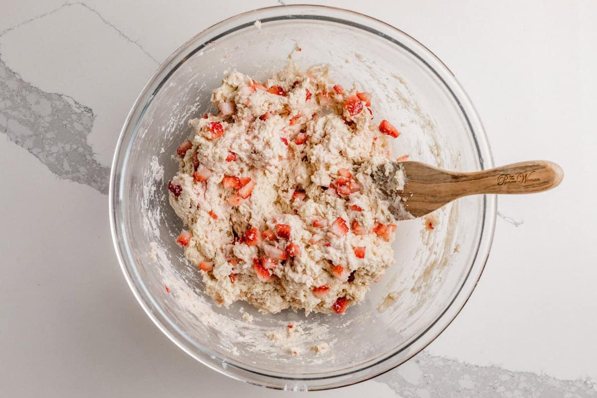 Sourdough strawberry biscuit dough in a bowl on a table.